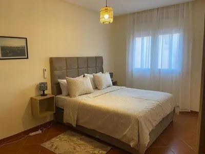 a bedroom with a large bed and a window at 4-person apartment Guéliz Blida in Marrakech