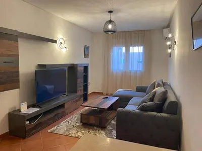 a living room with a couch and a flat screen tv at 4-person apartment Guéliz Blida in Marrakech