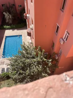 an overhead view of a swimming pool between two buildings at 4-person apartment Guéliz Blida in Marrakech
