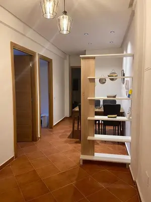a room with a kitchen with a table and a shelf at 4-person apartment Guéliz Blida in Marrakech