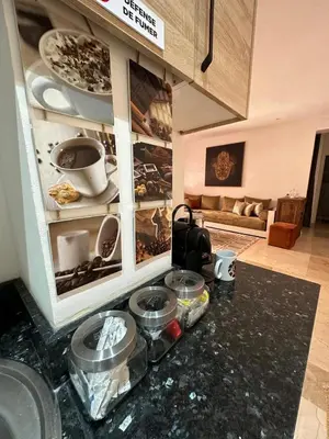 a kitchen with a counter top with bowls and plates at le CHARM J40 en face CTM Hivernage a 15mn de l'aéroport in Marrakech
