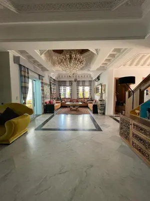 a large room with a chandelier and a living room at Villa Souzana in Marrakech