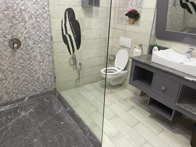 a bathroom with a shower with a toilet and a sink at Villa Souzana in Marrakech