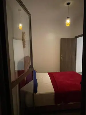 a bedroom with a bed with a red blanket at Marrakech Center Getaway Apartment in Marrakech