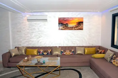 a living room with a couch and a table at Burj malak in Marrakech