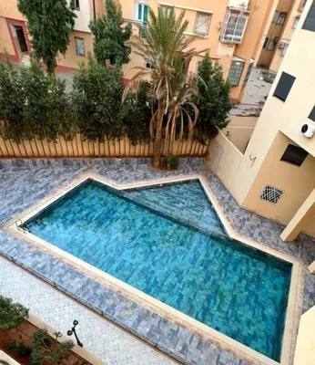 a large swimming pool in the middle of a building at Burj malak in Marrakech