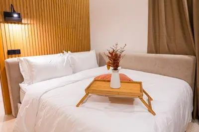a white vase on a table on a bed at Prestigia Golf Saphire in Marrakech