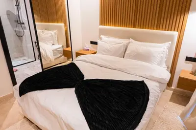 a bedroom with a large bed with a black bow on it at Prestigia Golf Saphire in Marrakech