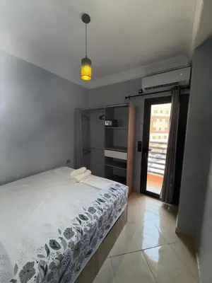 a bedroom with a bed and a window at charming apartment close to airport Marrakech in Marrakech