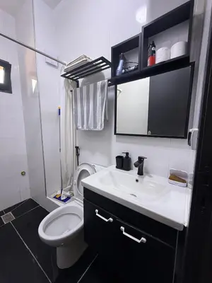 a bathroom with a white toilet and a sink at charming apartment close to airport Marrakech in Marrakech