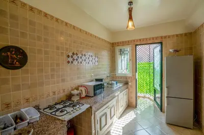 a kitchen with a stove and a refrigerator at Spacious and Family Apartment in Marrakech