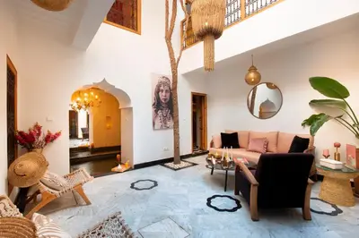 a living room with a couch and a tree at Riad Doll LallaZwina in Marrakech