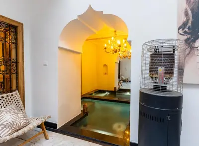 a room with a pool and a bird cage at Riad Doll LallaZwina in Marrakech