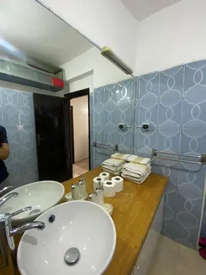 a bathroom with a sink and a mirror at appartement Alaoui in Marrakech