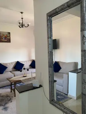 a mirror in a living room with a couch at appartement Alaoui in Marrakech