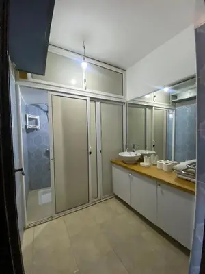a bathroom with a sink and a mirror at appartement Alaoui in Marrakech