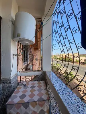 a balcony with a bench and a window at appartement Alaoui in Marrakech