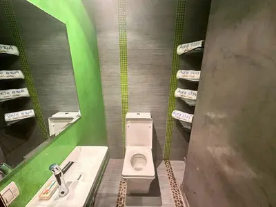a bathroom with a toilet and a sink and towels at Exclusive Luxury Stay with Pool, Jacuzzi and Service in Marrakech