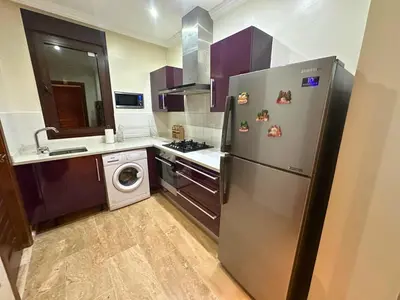 a kitchen with a stainless steel refrigerator and a dishwasher at Exclusive Luxury Stay with Pool, Jacuzzi and Service in Marrakech