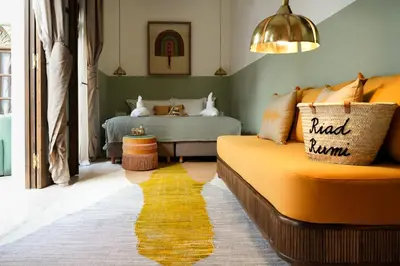 a living room with a couch and a bed at Riad Rumi Marrakech Medina in Marrakech