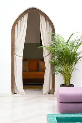 a room with a couch in a tent with a plant at Riad Rumi Marrakech Medina in Marrakech