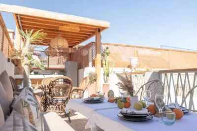 a table with a blue table cloth on a patio at Riad Rumi Marrakech Medina in Marrakech