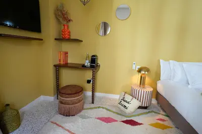 a living room with a bed and a table with a stool at Riad Rumi Marrakech Medina in Marrakech