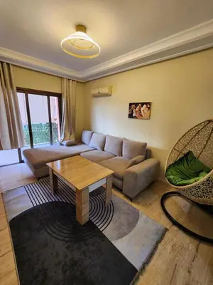 a living room with a couch and a table at Appartement de luxe in Marrakech
