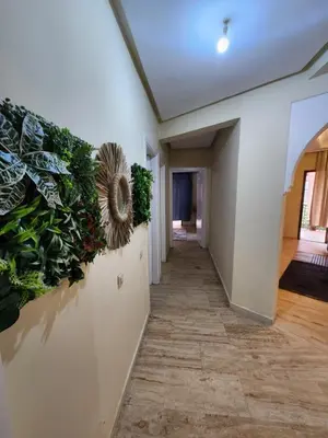 a hallway with plants on the wall at Appartement de luxe in Marrakech