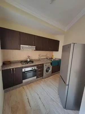 a kitchen with a stainless steel refrigerator and a dishwasher at Appartement de luxe in Marrakech