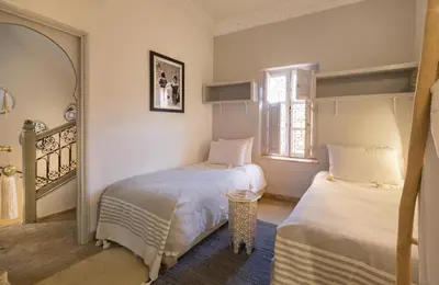 a bedroom with two beds and a window at riad medina marrakech in Marrakech