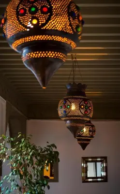 two chandeliers hanging from the ceiling in a room at riad medina marrakech in Marrakech
