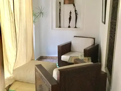 a living room with a couch and a chair at riad medina marrakech in Marrakech