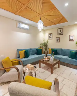 a living room with blue couches and a table at Riad Dar Lamia Marrakech Médina in Marrakech