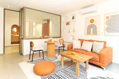 a living room with a couch and a table at Suite Soleil Charme, Confort & Emplacement Idéal in Marrakech
