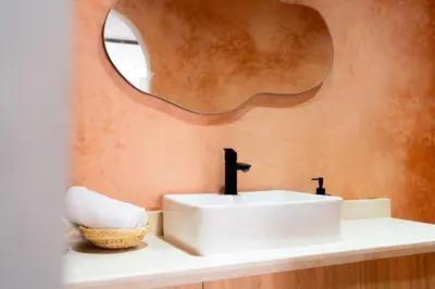 a bathroom with a white sink and a mirror at Suite Soleil Charme, Confort & Emplacement Idéal in Marrakech