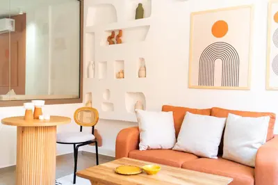 a living room with a couch and a table at Suite Soleil Charme, Confort & Emplacement Idéal in Marrakech