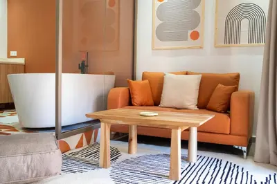 a living room with a couch and a coffee table at Terra Cotta Suite, Luxe & Relaxing Bath in Marrakech