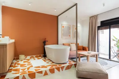 a bathroom with a tub in the middle of a room at Terra Cotta Suite, Luxe & Relaxing Bath in Marrakech