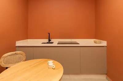 a kitchen with a wooden table and a sink at Terra Cotta Suite, Luxe & Relaxing Bath in Marrakech