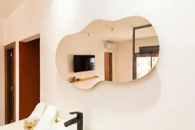 a mirror on the wall of a bathroom at Terra Cotta Suite, Luxe & Relaxing Bath in Marrakech