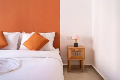 a bedroom with a bed and a side table with a lamp at Terra Cotta Suite, Luxe & Relaxing Bath in Marrakech