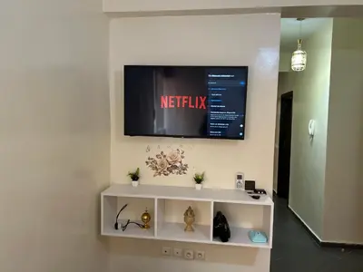 a television on a wall in a room at Le nid zen in Marrakech