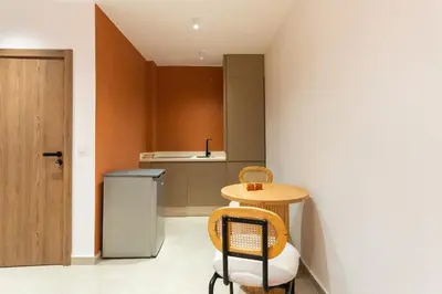 a small kitchen with a small table and a small refrigerator at Cozy suite Comfort et elegance in Marrakech