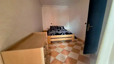 a small room with a bed in the corner of a room at Appartement Studio Sejourkech, Gueliz Plaza in Marrakech
