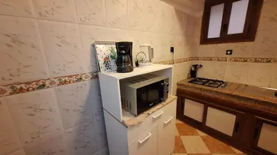 a kitchen with a microwave on top of a refrigerator at Appartement Studio Sejourkech, Gueliz Plaza in Marrakech