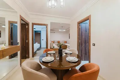 a dining room with a table and chairs at Modern Appart , Parking , Pool & Fiber wifi , Hivernage City Centre in Marrakech