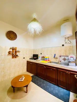a kitchen with a table and a counter top at Cozy Moroccan-style apartment in Marrakech