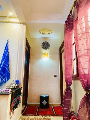 a hallway with pink curtains and a room at Cozy Moroccan-style apartment in Marrakech