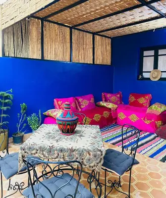 a living room with a table and a couch at Cozy Moroccan-style apartment in Marrakech